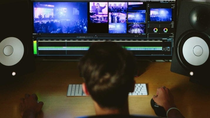 A business owner looks at a screen filled with different media to add to their website