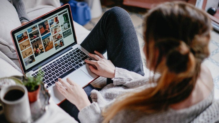 A woman looking at images on a laptop